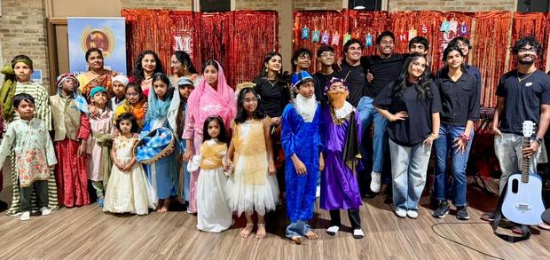 Children in nativity costumes with the adults who helped them
