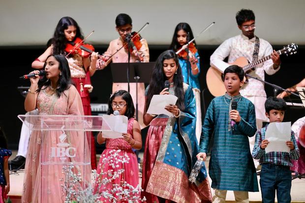 Singers and violinists leading worship