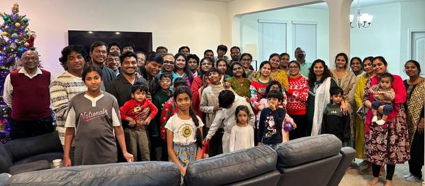 Families gathered by the Christmas tree