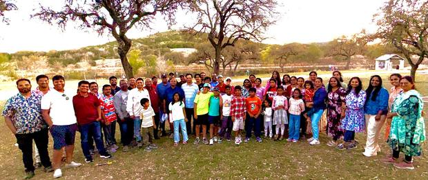The whole fellowship gathered outdoors at a park