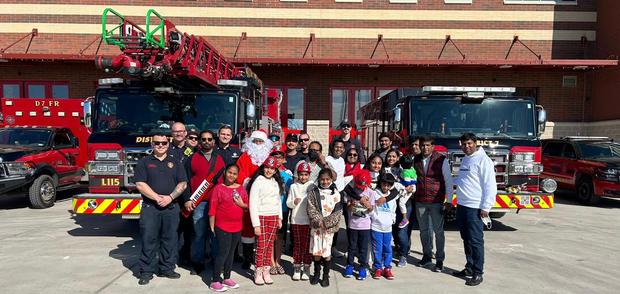 Fellowship families visiting the local fire station at Christmas