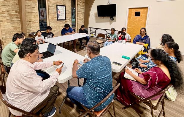 Bible study around the tables, Bibles open