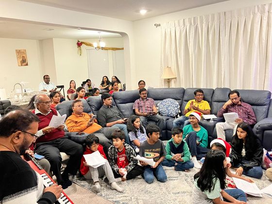 Families of the fellowship singing together at Christmas