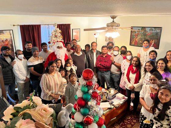 Members gathered in a home for a Christmas celebration